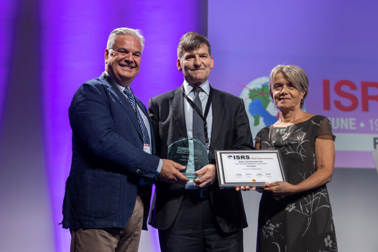Ian Paddick receiving the Fabrikant award at the ISRS 2022 congress event.