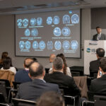 a crowd of people listening to a presentation