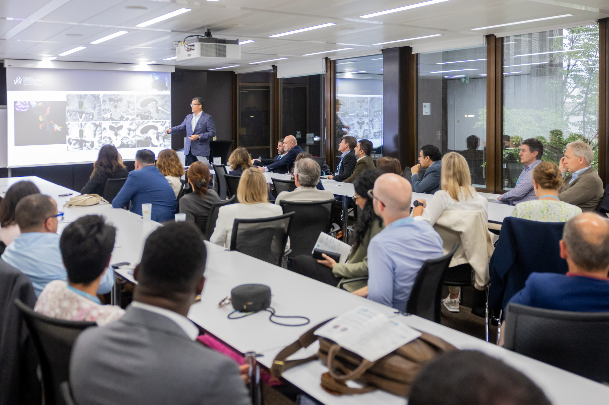 a group of ISRS members sitting together at a conference listening to a speaker